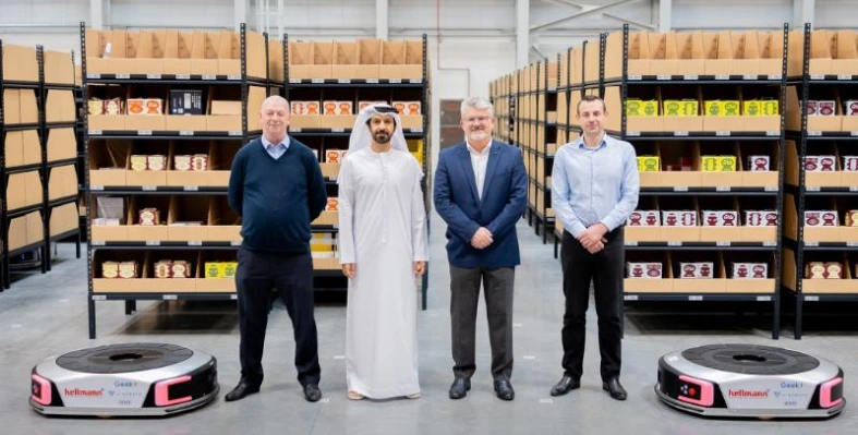 Four_men_standing_in_a_warehouse