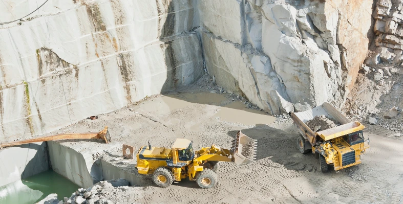 Construction work being carried out near a mountain